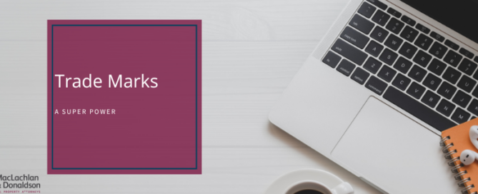 A picture of a laptop on a white desk with the test "Trade Marks - a Super Power"